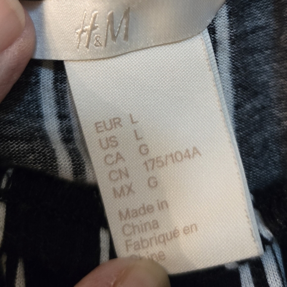 Cute off the shoulder black and white stripped blouse with elastic around waist. - Picture 2 of 5